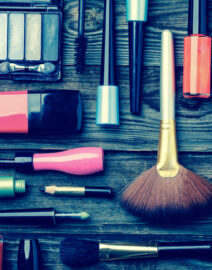 Cosmetics set on wooden background empty